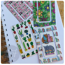 Load image into Gallery viewer, Set of colorful bookmarks with various designs on a notebook.